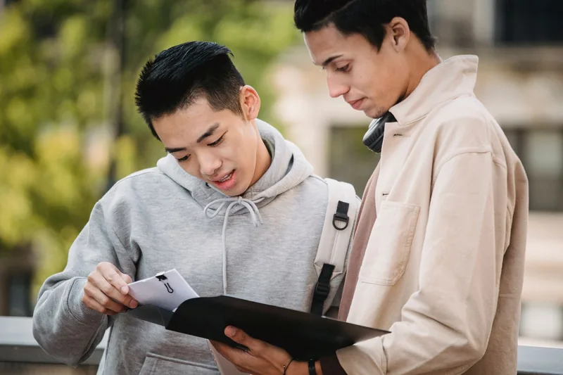 High school students reviewing transcript paperwork from an accredited homeschool program