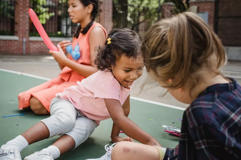 A diverse group of children playing and socializing together outdoors