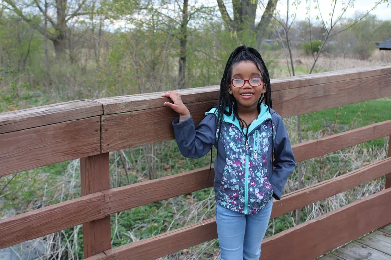 A calm, confident child standing tall — the kind of quiet self-assurance martial arts builds against bullying