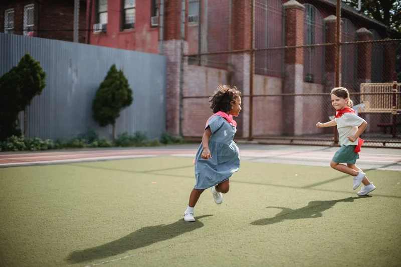 Children running and playing outdoors — meeting the daily 60 minutes of physical activity kids need